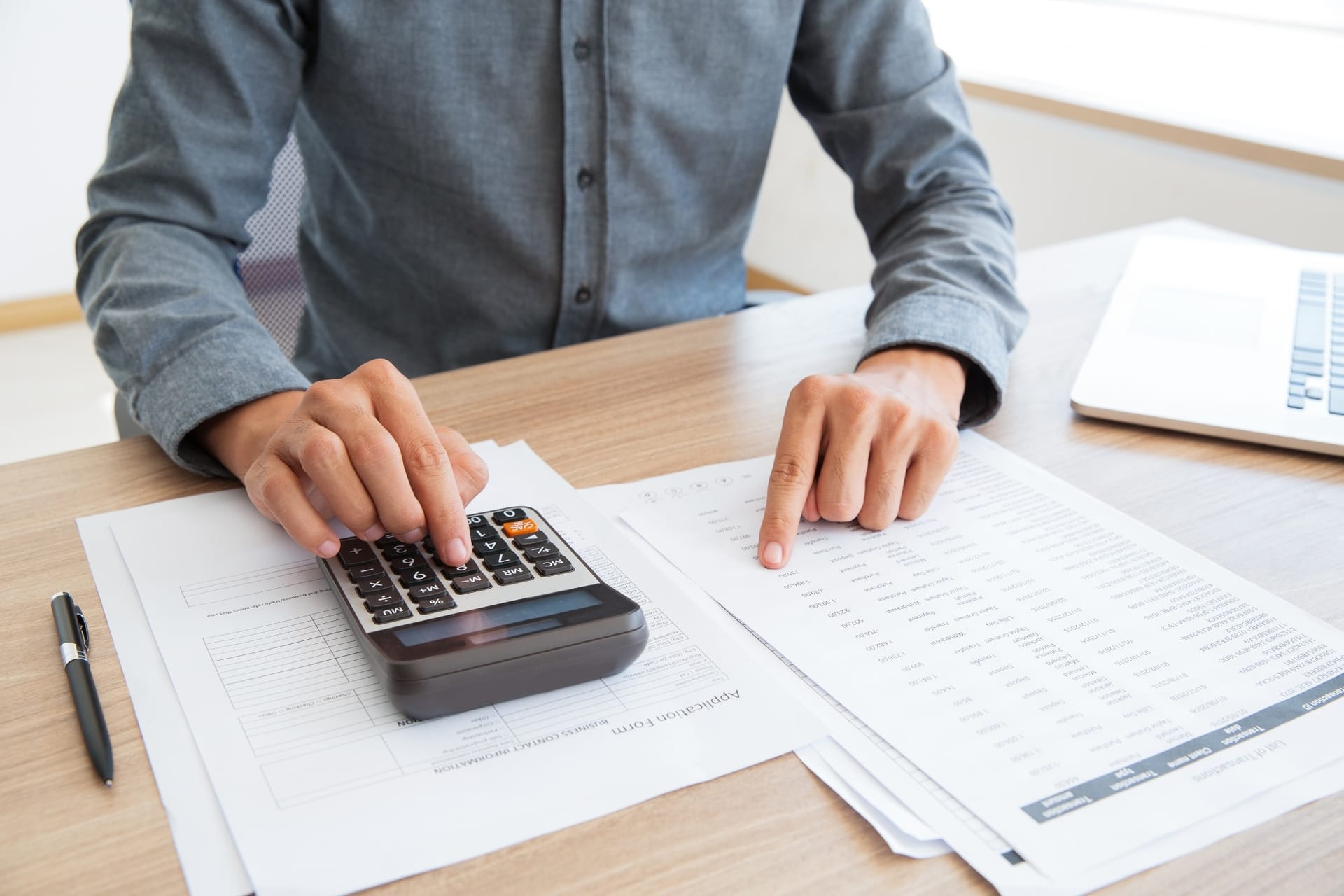 A careful desk review of a tax document with a pen and clear notes beside it